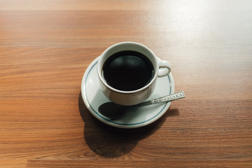 Coffee cup on the wooden floor in the morning.