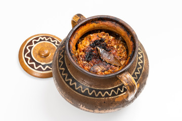 Hot, ready to serve traditional cabbage rolls with bay leaf in clay pot and lid.