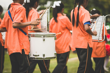 Marching band drummers perform in school parade