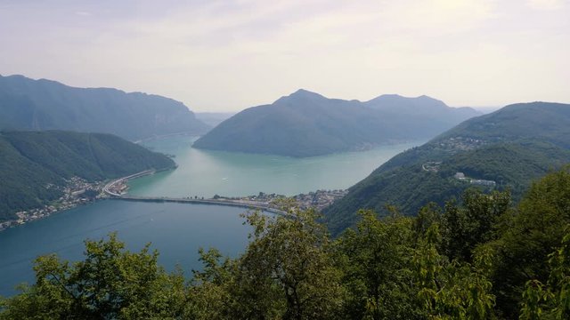 Switzerland, pan over Lugano lake and mountains, from Monte San Salvatore