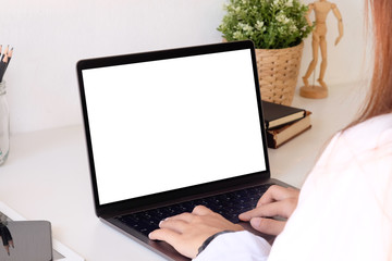 Fototapeta premium Female using mockup laptop computer on office desk.
