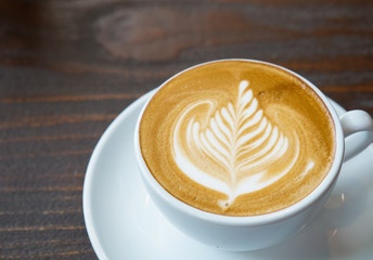 close up latte art coffee on wooden background, beverage concept.