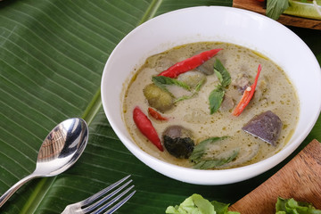 Traditional Thai food Green curry soup with top view on banana leaf.