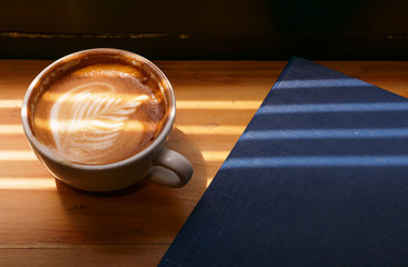 lattee coffe on wooden background and copyspace, drink and beverage concept.