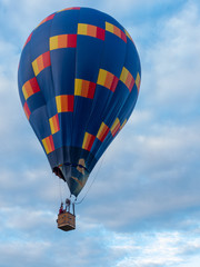 Hot air balloon flies among clouds on sky © Juriy