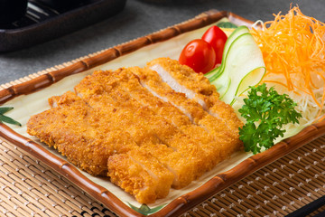 Japanese deep fried pork or tonkatsu set with rice in studio lighting.