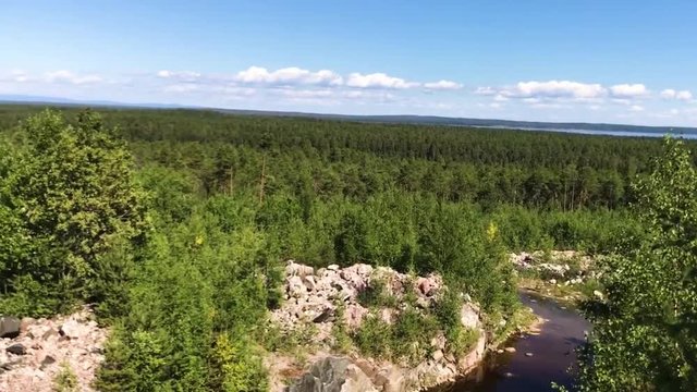 Beautiful camera motion  view, panorama view of forest in Karelia. Camera man standing above forest, moving camera from right to left.