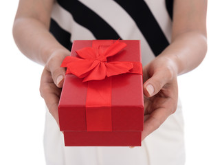 woman holding gift box in a gesture of giving isolated on white background