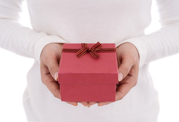 woman holding gift box in a gesture of giving isolated on white background