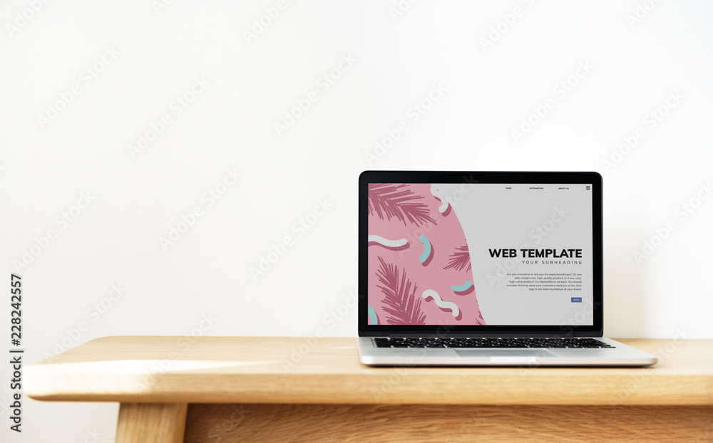 Wall mural laptop showing website template on a wooden table