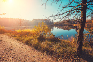 Early morning, sunrise over the lake. Rural landscape in autumn. Lake Walkway