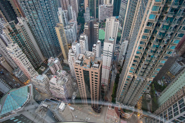 View from a glass elevator above the city and scyscrapers, vertigo inducing view looking down on a modern city