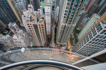 View from a glass elevator above the city and scyscrapers, vertigo inducing view looking down on a modern city - obrazy, fototapety, plakaty