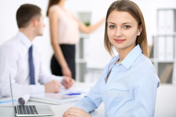 Obraz premium Portrait of a young business woman at meeting. Negotiation concept