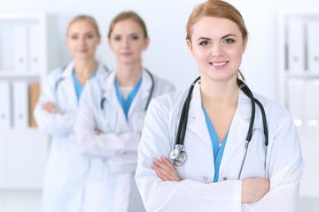 Group of medical doctors standing at hospital. Team of physicians ready to help patients. Medicine and health care concept