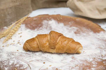 Fresh croissant on wooden table
