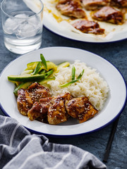 Hoisin Chicken. Traditional Asian cuisine. Chicken with sauce, rice and pickled cucumbers.