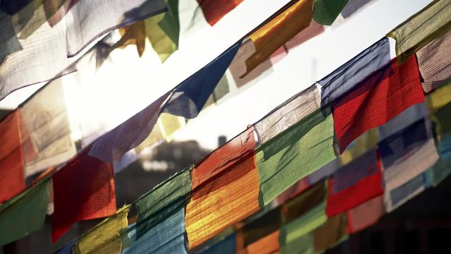 Colourful Buddhist prayer flags in Nepal waving in the wind. 4K, UHD