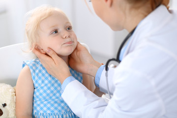 Fototapeta premium Doctor and a little blonde girl. Medicine and healthcare concept