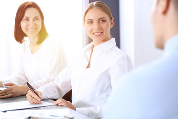 Obraz premium Group of business people or lawyers discussing terms of transaction in office. Meeting and teamwork concept