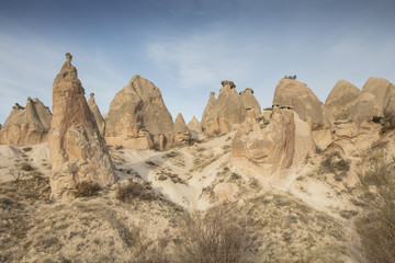 Fototapeta premium Unreal world of Cappadocia. Colorful sunrise in Red Rose valley in April. Cavusin village located, Nevsehir Province in the Cappadocia region of Turkey, Asia. Traveling concept background
