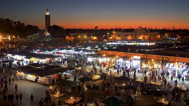 Jemaa el-Fnaa Square in Marrakesh, Morocco. Lots of people walking. Evening shot. 4K, UHD