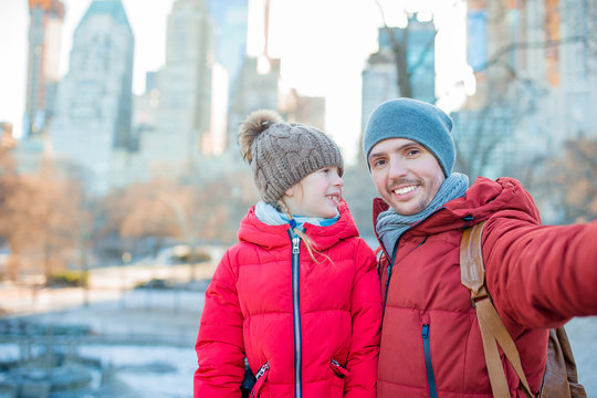 Adorable little girl and dad have fun in Central Park at New York City