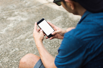 man holding smart phone for use internet with vintage tone. subject is blurred.