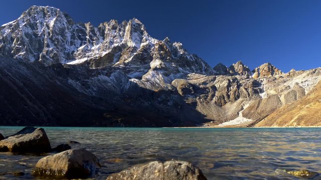 Gimbal shot of the Gokyo Lake and Himalayan snowy rocks in Nepal. Three pass trek. 4K, UHD