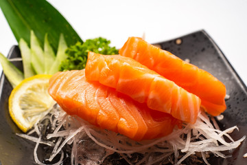 Sashimi, Salmon, Japanese food chopsticks and wasabi on the  table