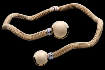 Golden bracelet on a black backgound