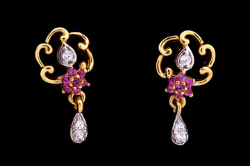 Golden earrings on a dark background