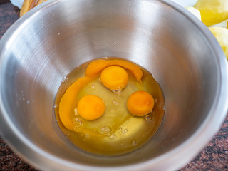 Top view of eggs in metallic bowl. Spanish omelet recipe