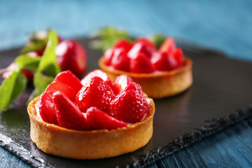 Tasty tartlet with strawberries on table, closeup - obrazy, fototapety, plakaty