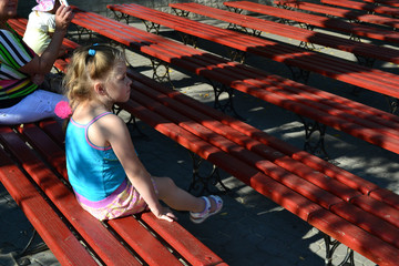 girl sitting on a bench street theater 