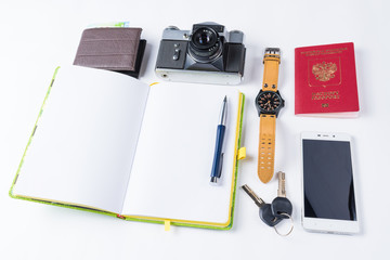Travel equipment isolated. Phone, watches, keys, notebook, passport, photo camera, purse on white background.