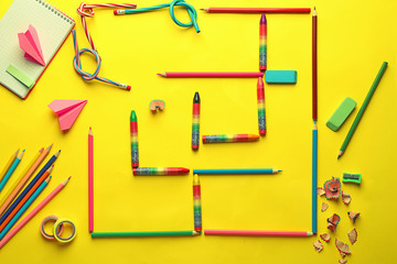 Composition with different school stationery on color background