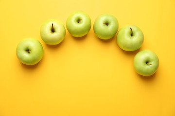 Ripe fresh apples on color background