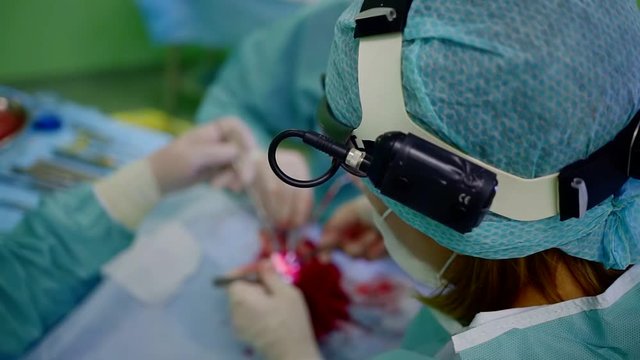 woman doctor is performing rhinoplasty procedure in medical clinic, correcting nasal septum