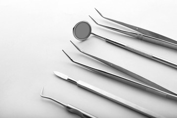 Dentist's tools on light background