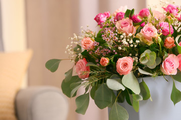 Gift box with beautiful flowers indoors