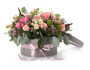 Gift box with beautiful flowers on white background