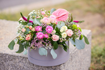 Gift box with beautiful flowers outdoors
