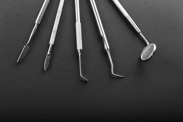 Dentist's tools on black background