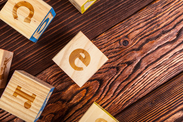 wooden block alphabet lay on wooden floor