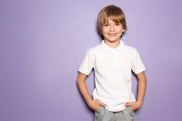 Little boy in t-shirt on color background