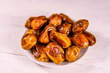 Date fruits on the white wooden table