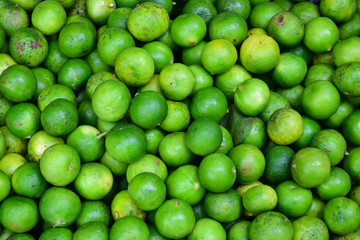 Green lemons at the market.