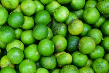 Green lemons at the market.