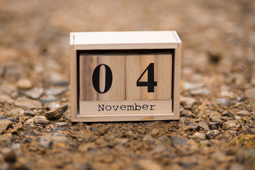 November 4th. Day 4 of November set on wooden calendar on wooden plank background. Autumn time 